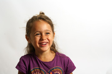 portrait on white background of a 4 year old Italian girl looking sideways