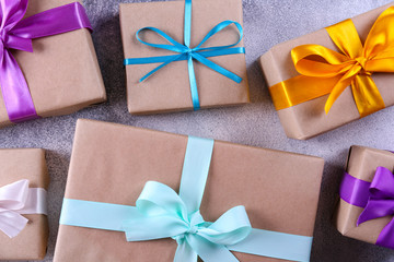 Simple composition with multiple presents wrapped in hand made blank craft paper gift wrap, pastel...