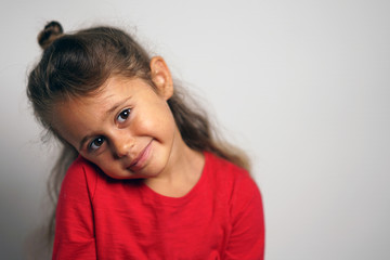 portrait on white background of a 4 year old Italian girl looking sideways