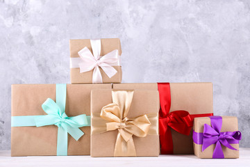 Simple composition with multiple presents wrapped in hand made blank craft paper gift wrap, pastel...