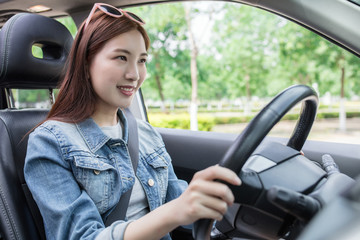 Fototapeta na wymiar LWTWL0025816 Young Happy Smiling Woman driving Car