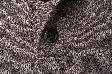 Close-up fragment of a gray knitted warm jacket