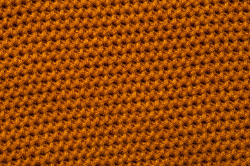 Close-up of an orange knitted fabric