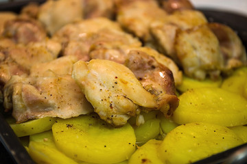 Home cooking. Chicken fillet is baked with potatoes on a baking sheet. Moscow, Russia.