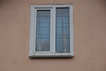 Fototapeta na wymiar one big white window on a brown wall