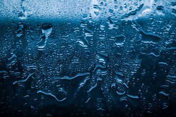 Water texture abstract background, aqua drops on blue glass as science macro element, rainy weather...