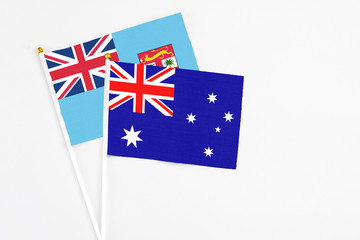 Australia and Fiji stick flags on white background. High quality fabric, miniature national flag. Peaceful global concept.White floor for copy space.