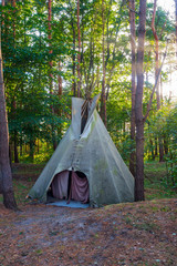 Wigwam teepee in the forest