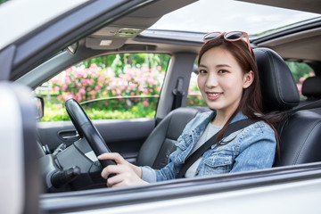 Fototapeta na wymiar LWTWL0025849 Young Happy Smiling Woman driving Car