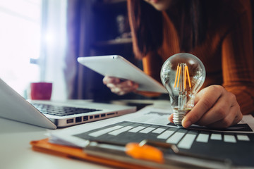 business hand showing creative business strategy with light bulb as concept
