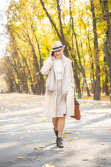 Modern businesswoman walking along the park road