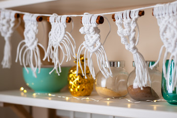 Handmade crafted macrame hanging from kitchen shelf