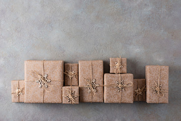 Christmas gifts in paper packaging on a gray background. Concept: packaging and decor from...