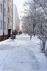 Sidewalk in the snow in a typical Polish block in winter