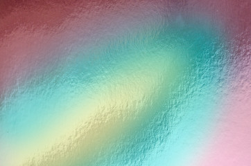Holographic foil paper. Colorful trendy background close up. Futuristic texture, top view.