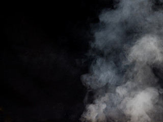 Light smoke texture on a dark background. Studio photography