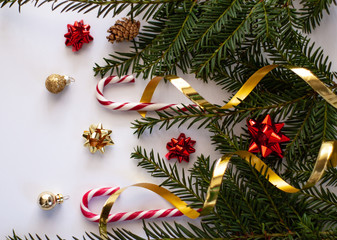 .Christmas decorative background with pine branches,candy and christmas ball on the white background. Christmas Holiday Concept. copy space, top view.