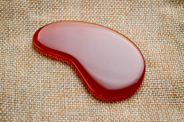 Guasha scrapers for body massage according to the old method were shot on a background of canvas