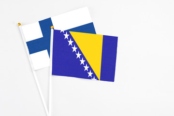 Bosnia Herzegovina and Finland stick flags on white background. High quality fabric, miniature...