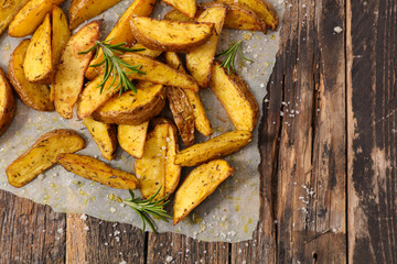 rustic french fries with rosemary on wood background
