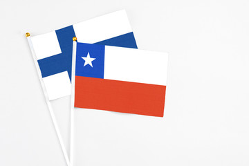 Chile and Finland stick flags on white background. High quality fabric, miniature national flag. Peaceful global concept.White floor for copy space.
