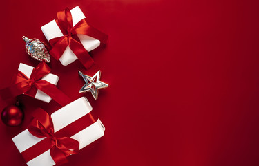 Christmas card with gift boxes on a red background. White Christmas gift boxes on a red background....