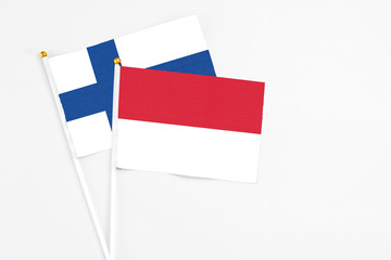 Indonesia and Finland stick flags on white background. High quality fabric, miniature national flag. Peaceful global concept.White floor for copy space.