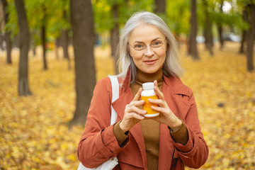 Smiling woman standing in a city park