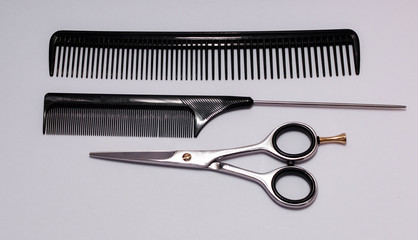 scissors and comb isolated on white