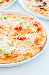 Close up of pizza caesar on a plate.