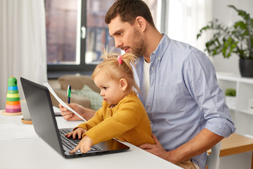 multi-tasking, freelance and fatherhood concept - working father with baby daughter and laptop computer at home office