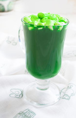 green drink with marshmallows in a glass