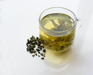 Green tea is brewed in a cup.
