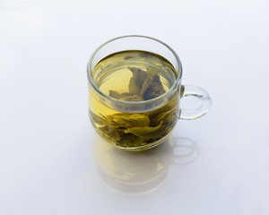 Green tea is brewed in a cup.
