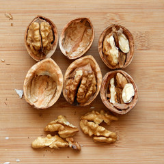 Walnuts kernels on wooden desk with color background, Whole walnuts and Half walnuts	