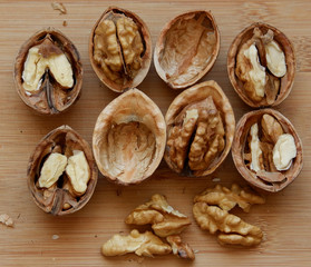 Walnuts kernels on wooden desk with color background, Whole walnuts and Half walnuts	