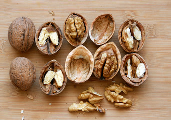 Walnuts kernels on wooden desk with color background, Whole walnuts and Half walnuts	