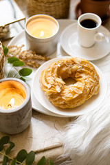 Simple real breakfast with coffee and custard cake on white plate