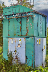 Distributing transformer substation in countryside.