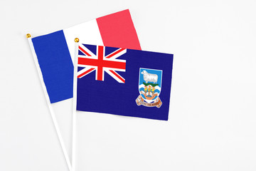 Falkland Islands and France stick flags on white background. High quality fabric, miniature...