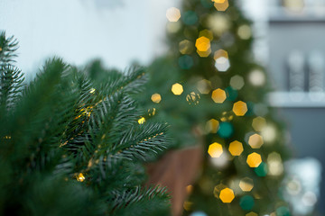 Christmas light with Christmas tree decorations in the form of a ball, coniferous branches on a wooden table. View from above.