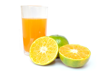 100% of fresh Orange juice in glass with Green oranges and sliced i