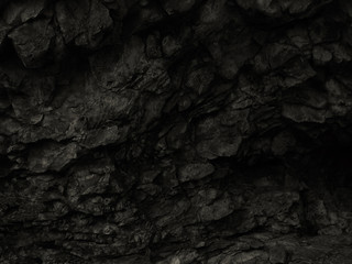 Black abstract stone background. Dark rock texture. Black grunge background. Mountain close-up.