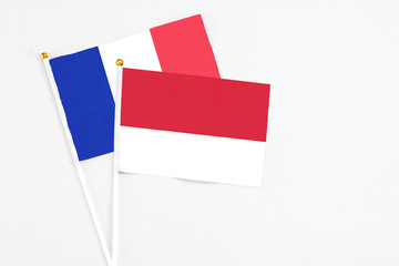 Monaco and France stick flags on white background. High quality fabric, miniature national flag. Peaceful global concept.White floor for copy space.