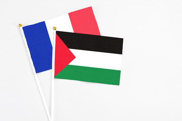 Palestine and France stick flags on white background. High quality fabric, miniature national flag....