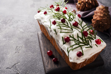 Traditional Christmas cake with cranberries on gray table background. Horizontal. Copy space.