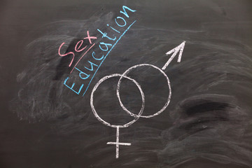 Sex Education. Male and female sex symbol on black chalkboard