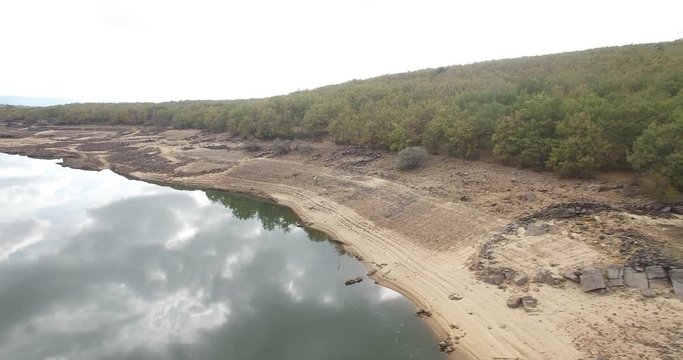 Tower of a church in a swamp almost dry, La cuerda del pozo, Soria, Vinuesa, Spain. Filmed by a drone