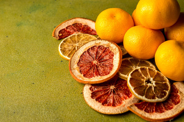 healthy citruses and tropical fruits on a beautiful green background