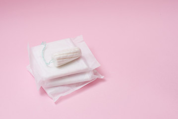 Menstrual tampon and pads on a pink background. Menstruation time. Hygiene and protection. copy space